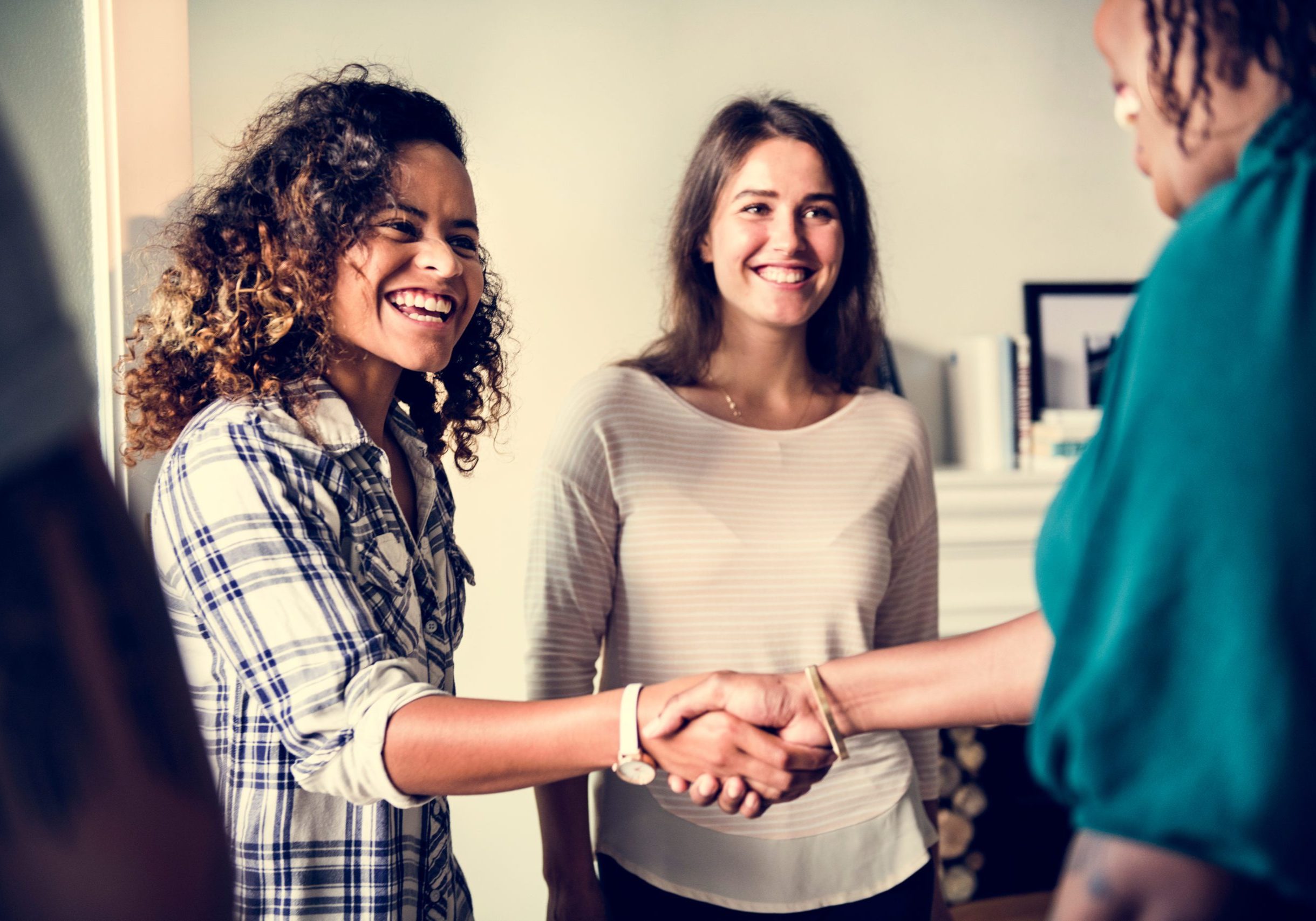 Diverse woman shaking hands